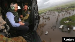 Australian Prime Minister Malcolm Turnbull looks at damaged and flooded areas from aboard an Australian Army helicopter after Cyclone Debbie passed through the area near the town of Bowen, south of the northern Queensland town of Townsville in Australia, 