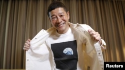 Japanese billionaire Yusaku Maezawa poses with his T-shirt bearing an image of Earth during an interview with Reuters in Tokyo, Japan, March 3, 2021. (REUTERS/Kim Kyung-Hoon)