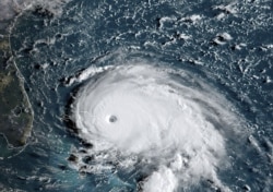 This satellite image from NOAA/RAMMB, shows Tropical Storm Dorian as it approached the Bahamas and Florida, September 1, 2019.