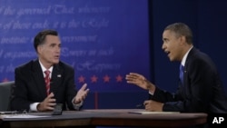 President Barack Obama, right, and Republican presidential nominee Mitt Romney discuss a point during the third presidential debate at Lynn University in Boca Raton, Florida, October 22, 2012.