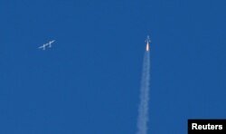 The SpaceShipTwo passenger craft rockets away from the WhiteKnightTwo carrier airplane above Mojave, California, Feb. 22, 2019.