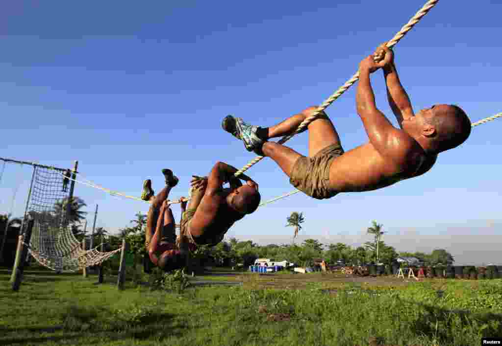New recruits of the Philippine Navy Seals cross a rope as part of a physical training exercise at the Philippine Navy headquarters in Sangley Point, Cavite city, south of Manila. 