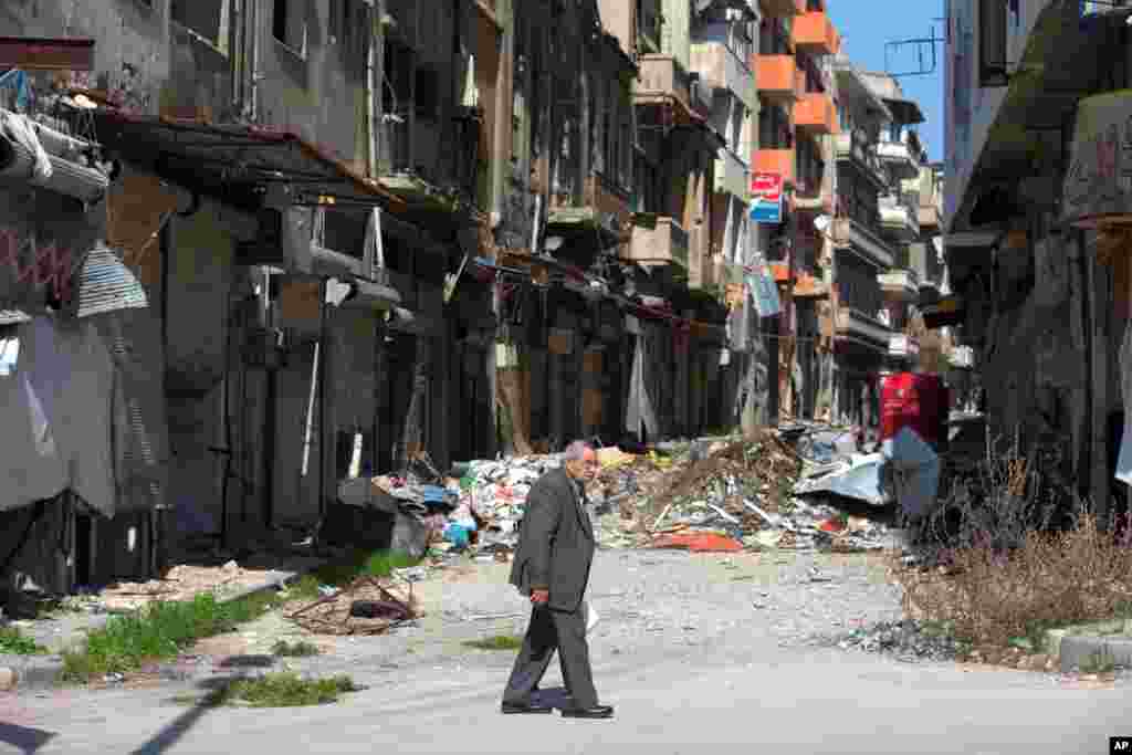 A Syrian man walks through a devastated part of the old city of Homs, Feb. 26, 2016.