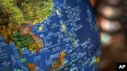 FILE - A globe shows the islands on the South China Sea with nine-dash line claims under Chinese territory on display at a bookstore in Beijing, July 13, 2018. 