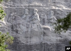 FILE - This June 23, 2015, file photo shows a carving depicting confederates Stonewall Jackson, Robert E. Lee and Jefferson Davis, in Stone Mountain, Ga.