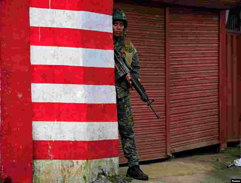 Seorang tentara Filipina mengambil posisi dalam pertempuran melawan militan kelompok Maute yang berafiliasi dengan ISIS di Marawi, Filipina selatan.