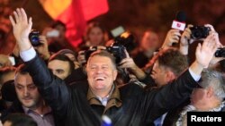 Romanian presidential candidate Klaus Iohannis celebrates his victory in the election run-off, with protesters in central Bucharest, November 16, 2014.