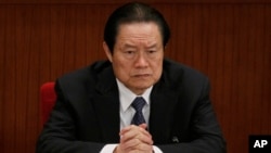 FILE - Zhou Yongkang, then Chinese Communist Party Politburo Standing Committee member in charge of security, attends a plenary session of the National People's Congress at the Great Hall of the People in Beijing, China. 