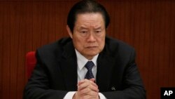 FILE - Zhou Yongkang, then Chinese Communist Party Politburo Standing Committee member in charge of security, attends a plenary session of the National People's Congress at the Great Hall of the People in Beijing, China. 