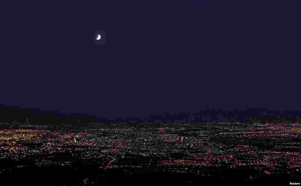 A lunar eclipse over San Jose city in Rancho Redondo, Costa Rica, April 4, 2015