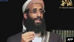 FILE - Anwar al-Awlaki, a U.S.-born cleric linked to al-Qaida's Yemen-based wing, gives a religious lecture in this still image taken from video. A terrorism suspect behind bars for allegedly helping al-Awlaki was indicted for ordering a hit on federal judge.