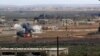 FILE - An image made from militant video posted online by the Aamaq News Agency, a media arm of the Islamic State group, Jan. 9, 2017, purports to show the moment of a Turkish missile strike, in the northern Syrian town of al-Bab, in Aleppo province, Syria. 