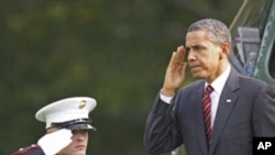 President Barack Obama returns a salute as he steps off the Marine One helicopter on the South Lawn at the White House in Washington, Monday, Oct. 10, 2011.