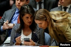FILE - United States Ambassador to the United Nations Nikki Haley talks with one of her delegation members during the United Nations Security Council meeting on Syria at the U.N. headquarters in New York, April 13, 2018.