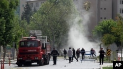 Security officers and firefighters work moments after an explosion outside the Police headquarters in Gaziantep, Turkey, May 1, 2016. 