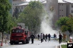 Security officers and firefighters work moments after an explosion outside the Police headquarters in Gaziantep, Turkey, May 1, 2016.