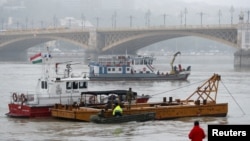 A person watches rescue boats after a ship accident that killed several people on the Danube river in Budapest, Hungary, May 30, 2019.