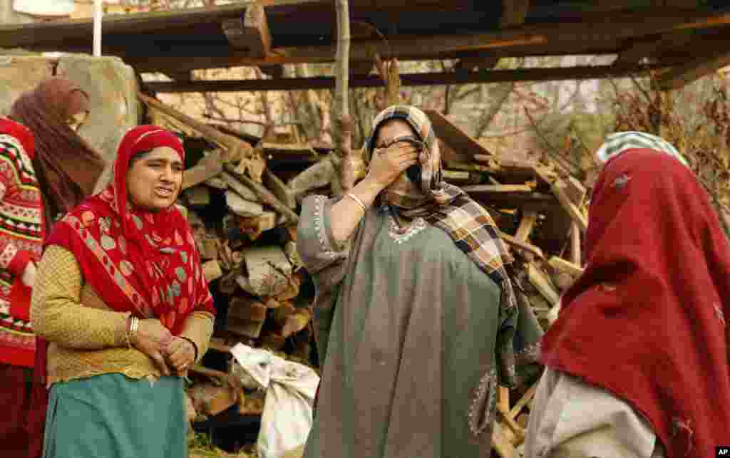 A Kashmiri woman weeps at the site of a gunbattle on the outskirts of Srinagar, India, Friday, Dec. 5, 2014. 