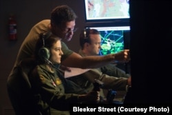 (Left to Right) Actress Phoebe Fox, director Gavin Hood and actor Aaron Paul on the set of EYE IN THE SKY, a Bleecker Street release.