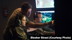(Left to Right) Actress Phoebe Fox, director Gavin Hood and actor Aaron Paul on the set of EYE IN THE SKY, a Bleecker Street release.
