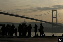 People stand by the Bosporus Strait in Istanbul, Jan. 4, 2017. These days, with a string of terror attacks targeting Istanbul still fresh in his memory, some residents say they are changing their daily routines.