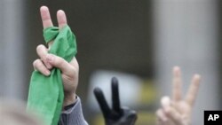 Protesters make the victory sign, as they demonstrate in front of the Iranian embassy in Brussels to show solidarity to the people of Iran.