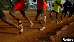 FILE - Athletes exercise in the early morning in the sports ground of the University of Eldoret in western Kenya, March 21, 2016. 