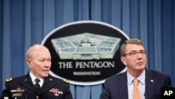 FILE - Defense Secretary Ash Carter, right, accompanied by Joint Chiefs Chairman Gen. Martin Dempsey speaks during a news conference at the Pentagon, April 16, 2015. 