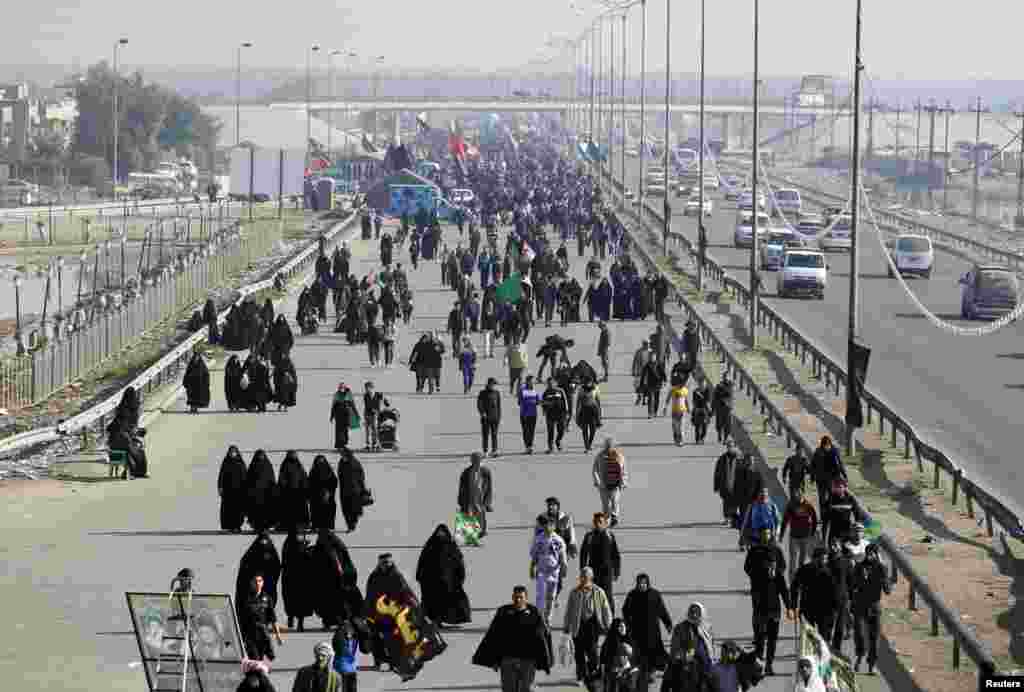 Iraqi Shi'ite Muslim pilgrims walk to the holy city of Karbala to mark Arbaeen in Baghdad's Doura district, Iraq, December 31, 2012.