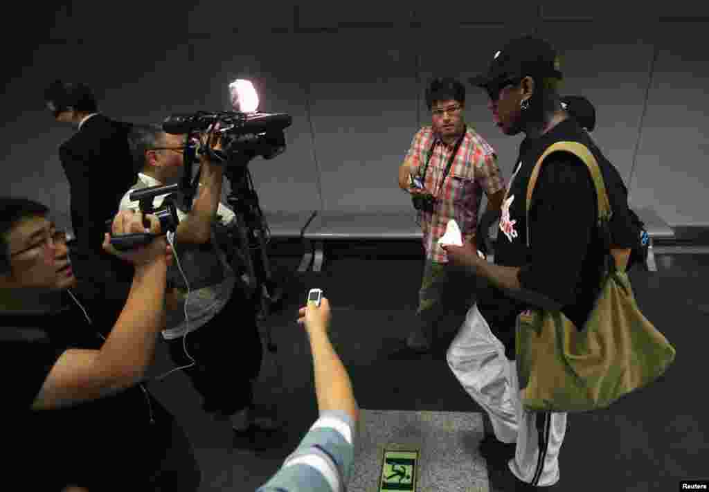 Former basketball star Dennis Rodman talks to media as he transits to Pyongyang from Beijing Capital International Airport, Sept. 3, 2013.