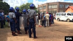 Riot police ready to pounce at a street march organized by members of the National Electoral Reform Agenda (NERA), protesting against the Zimbabwe Electoral Commission's failure to conduct a transparent voter registration exercise.