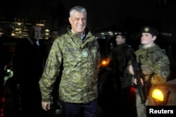 FILE - Kosovo's President Hashim Thaci walks past soldiers of Kosovo Security Force during the army formation ceremony in Pristina, Kosovo, Dec. 14, 2018.