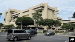 FILE - The federal building housing U.S. District Court in Honolulu, March 7, 2014. U.S. District Judge Derrick Watson halted President Donald Trump's revised travel ban this month, hours before it was due to take effect.