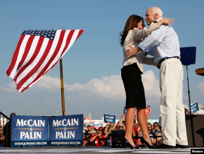 US Republican presidential candidate Senator John McCain (R-AZ) and his running mate Alaska Governor Sarah Palin hug during a campaign stop in O'Fallon, Missouri August 31, 2008.