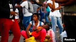 Migrants wait as they hope to receive help from the Mexican government to obtain humanitarian visas to transit Mexican territory, in Tapachula, Mexico, Dec. 4, 2021. 