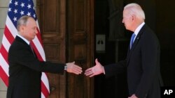 FILE - U.S. President Joe Biden and Russian President Vladimir Putin, arrive to meet at the 'Villa la Grange', in Geneva, Switzerland, June 16, 2021.