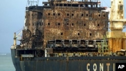 The MV Pacific Express, which was set on fire by suspected Somali pirates, is towed by Kenya Ports Authority, Sept. 21, 2011.