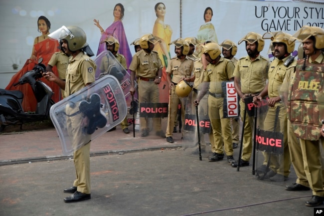 Policemen stand guard near the state secretariat anticipating protests following reports of two women entering the Sabarimala temple in Thiruvananthapuram, Kerala, India, Jan. 2, 2019
