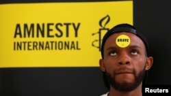FILE - Human rights campaigner looks on during the release of an Amnesty International report in Abuja, Nigeria, May 16, 2017. 