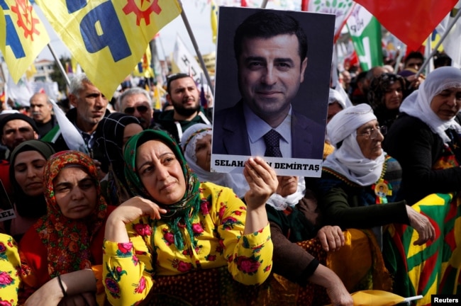 A demonstrator holds a picture of Selahattin Demirtas, jailed former leader of pro-Kurdish Peoples' Democratic Party (HDP), during a rally in Istanbul, Turkey, Feb. 3, 2019.