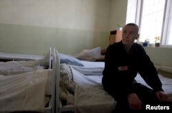 FILE - An inmate sits in the multi-drug-resistant tuberculosis ward in a prison hospital in Russia.