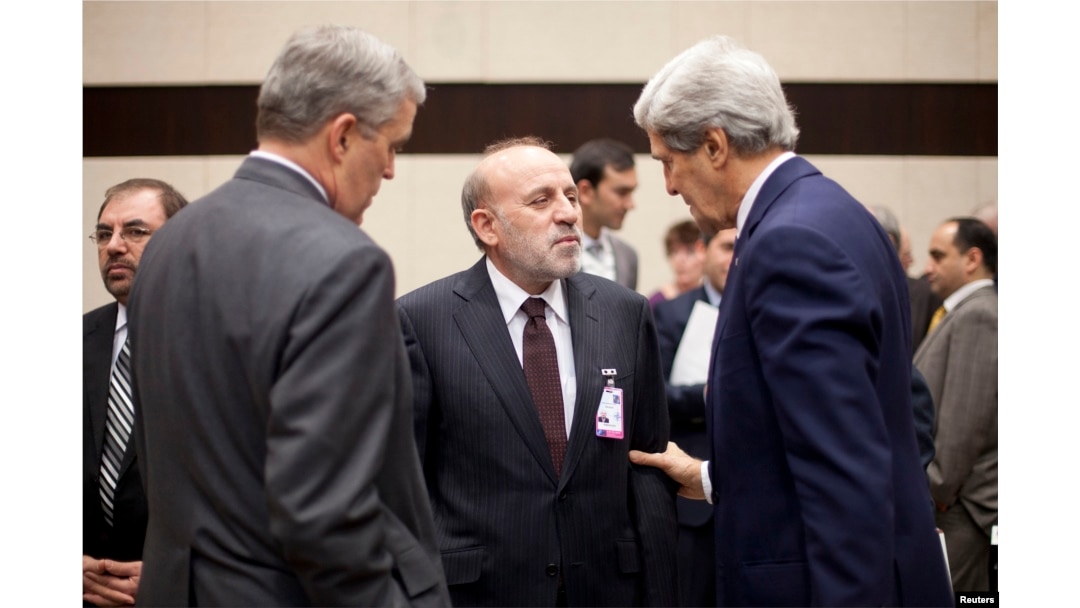 U.S. Secretary of State John Kerry, right, and U.S. Ambassador to NATO Douglas Lute, left, speak with Afghanistan's Interior Minister Mohammed Umer Daudzai at NATO headquarters in Brussels, Dec. 4, 2013