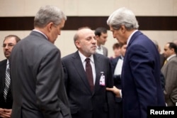 U.S. Secretary of State John Kerry, right, and U.S. Ambassador to NATO Douglas Lute, left, speak with Afghanistan's Interior Minister Mohammed Umer Daudzai at NATO headquarters in Brussels, Dec. 4, 2013