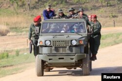 Venezuela's President Nicolas Maduro drives a vehicle during his visit to a military training center in El Pao, Venezuela, May 4, 2019.