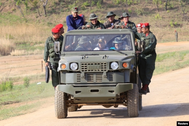 Venezuela's President Nicolas Maduro drives a vehicle during his visit to a military training center in El Pao, Venezuela, May 4, 2019.