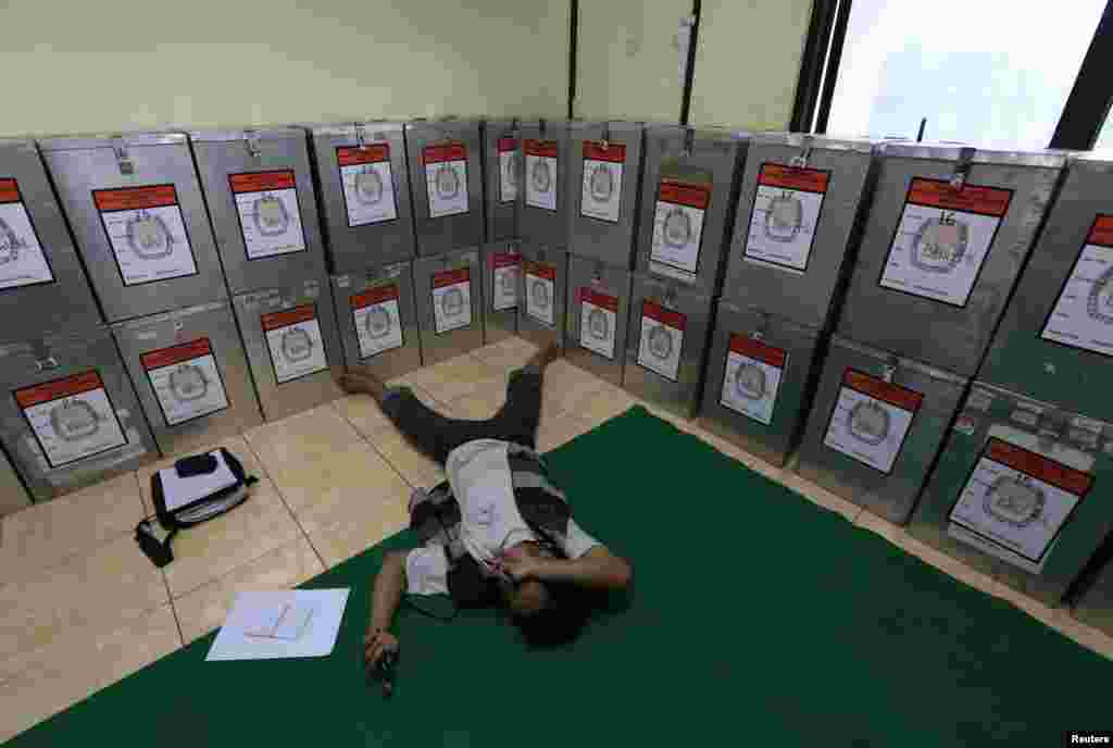 A man take a rest near ballot boxes at Bendungan Hilir in Jakarta, July 10, 2014.