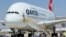 In this July 6, 2020, file photo, a Qantas Airbus A380 arrives in Victorville, Calif. Qantas said that once a virus vaccine becomes widely available, the carrier will likely require it before passengers can travel abroad or land in Australia. (AP Photo/Matt Hartman, File)