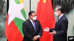 In this photo released by China's Xinhua News Agency, Chinese Foreign Minister Wang Yi meets with Myanmar's Foreign Minister Wunna Maung Lwin in Tunxi in eastern China's Anhui Province, Friday, April 1, 2022.