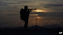 FILE - A Pakistani border security guard stands alert at Pakistan-Afghanistan border post, Chaman in Pakistan, May 5, 2017. The U.S. recently decided to withhold $50 million in military aid to Pakistan for failing to do enough against the Haqqani network.