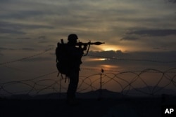 FILE - A Pakistani border security guard stands alert at a Pakistan-Afghanistan border post at Chaman, Pakistan, May 5, 2017.